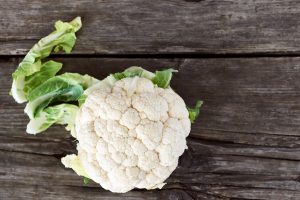 Beautiful and yummy cauliflower on an old wooden table